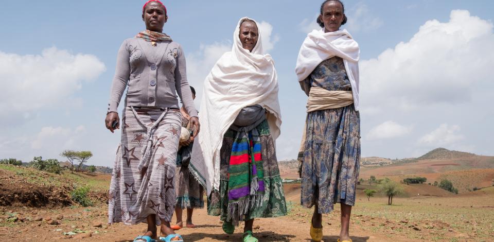 Wlubnesh Fentaye Adane, 50, center, leaves the health post with CBM-supported health extension worker Asefu Ayalew, left, in Faya, Amhara Region, Ethiopia, on May 20, 2017. Also pictured is Adane's sister, Birhanie Mekonnen, at right.