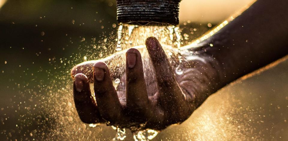 An image showing a hand under a stream of water